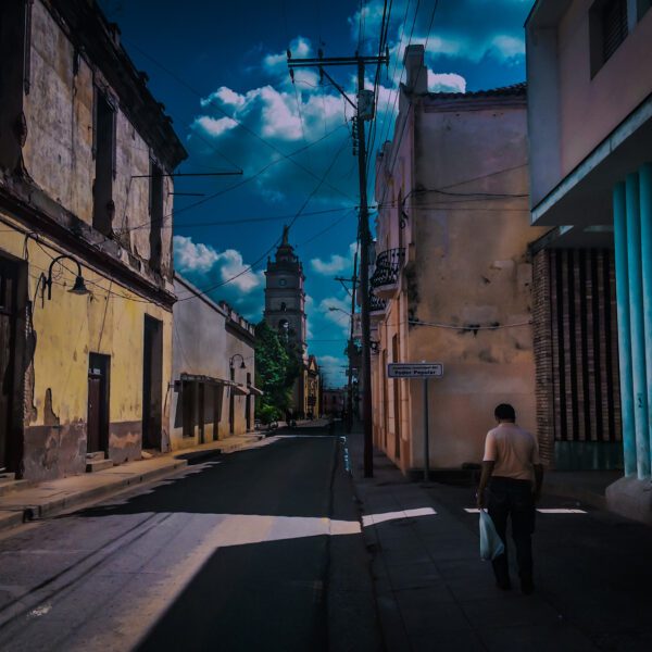 A man walking down a street in Cuba.