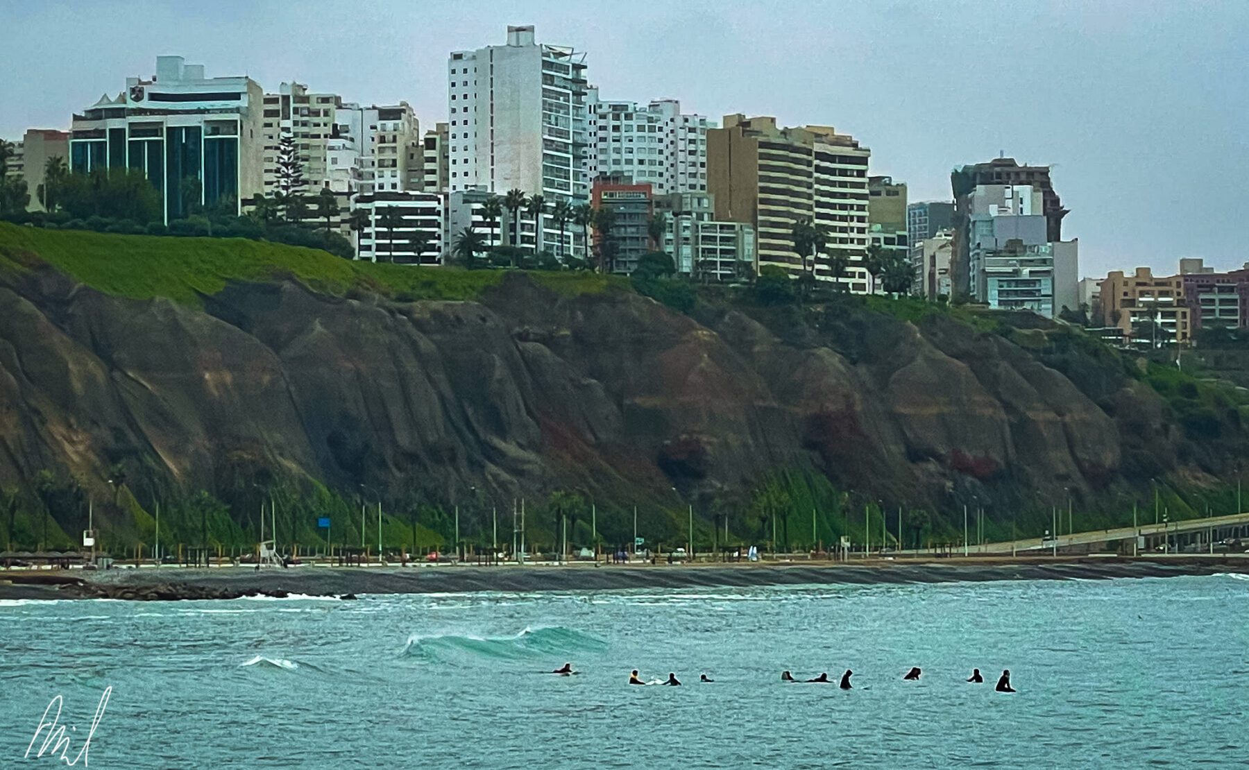 A group of people are surfing in the ocean near Peru.
