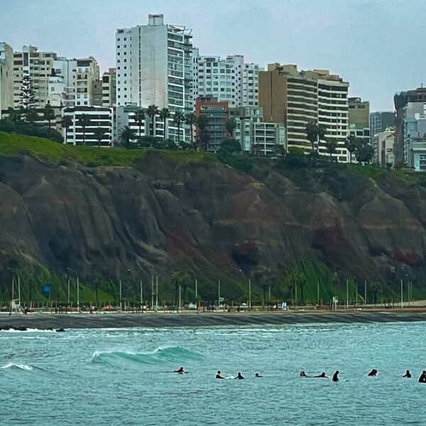 A group of people are surfing in the ocean near Peru.