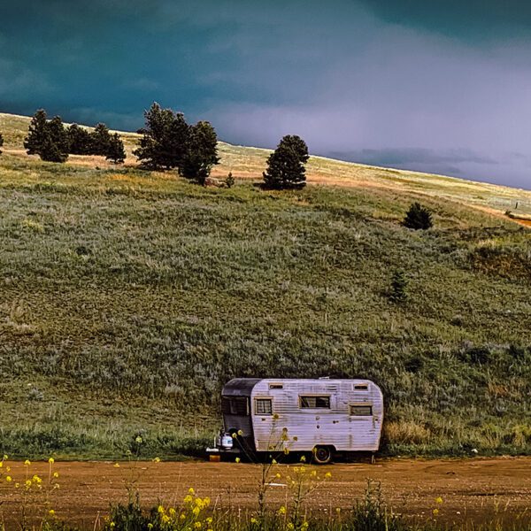 A Montana sits on a hill under a stormy sky.